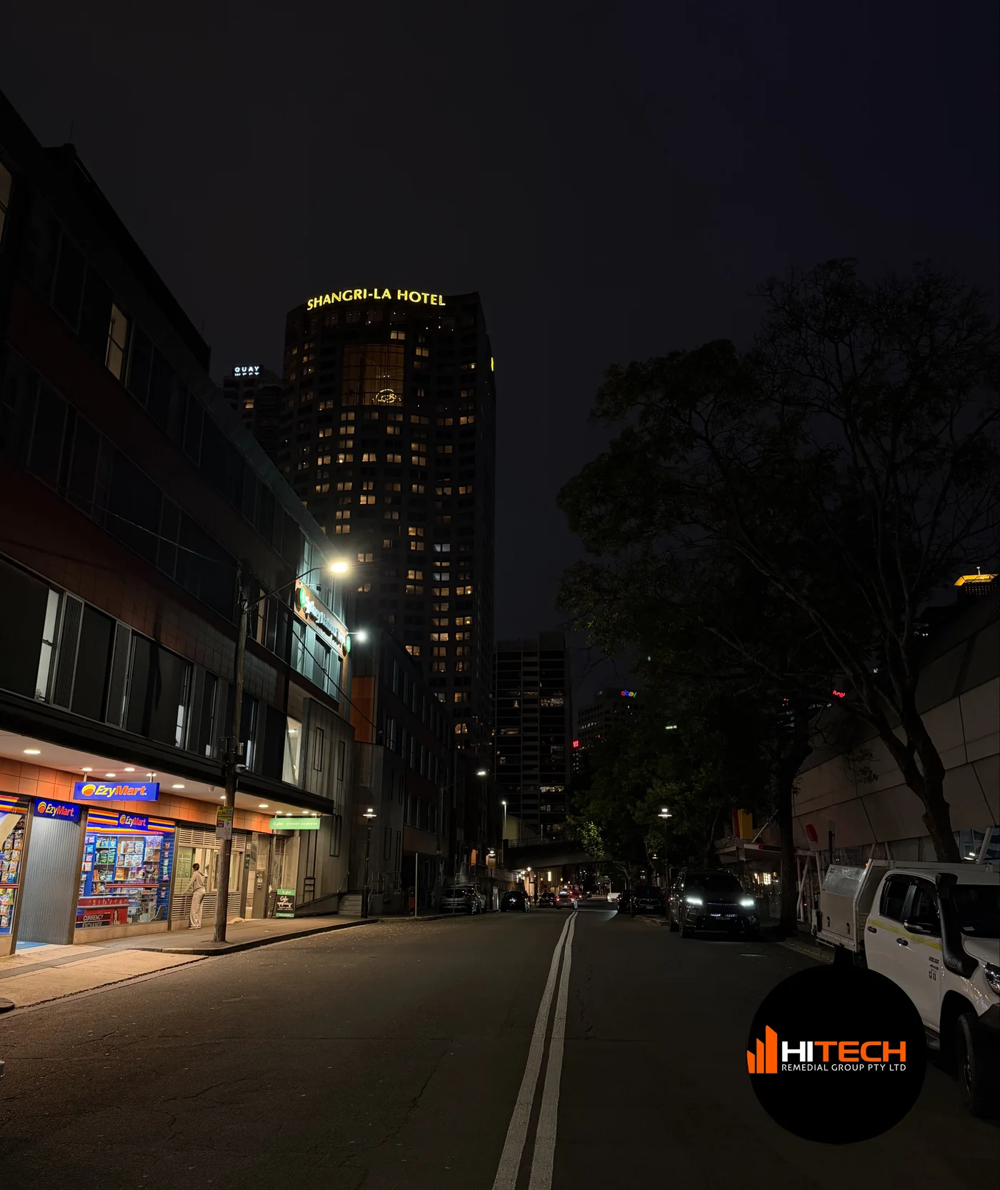 Shangri-La Sydney rising above the street at night